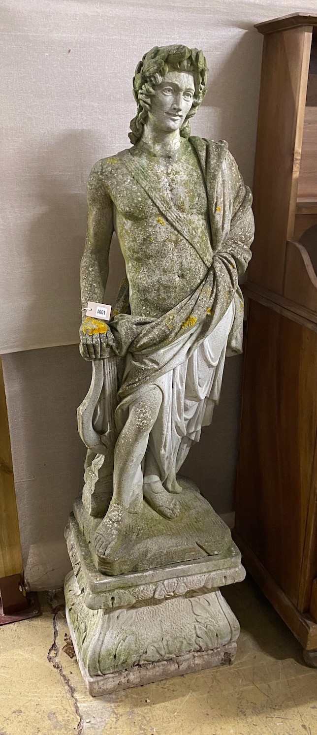 A reconstituted stone garden ornament, robed classical figure with lyre on square plinth height 165cm.
